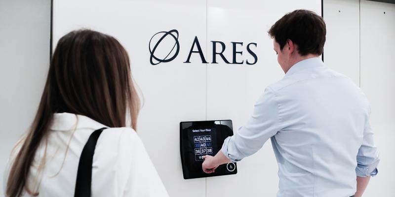 Two employees waiting in front of elevator