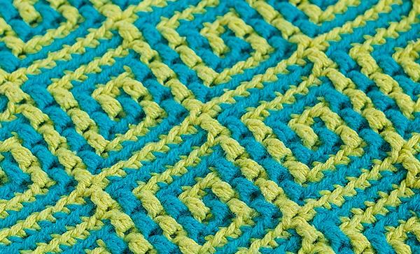Knitted jacquard fabric with yellow blue geometric pattern Knitted jacquard fabric with yellow blue geometric pattern