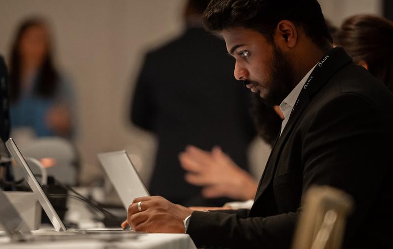 A professional working on a laptop