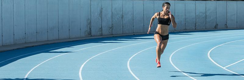 woman sprinting on a track